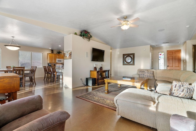 living room with lofted ceiling, concrete floors, and ceiling fan