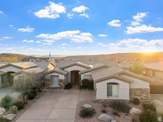 view of front of home with a mountain view and a patio