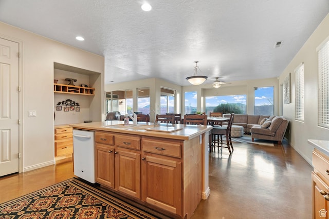kitchen with sink, dishwasher, concrete flooring, a textured ceiling, and a center island with sink