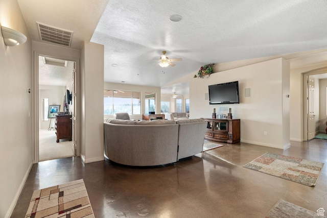 living room featuring ceiling fan, lofted ceiling, and a textured ceiling