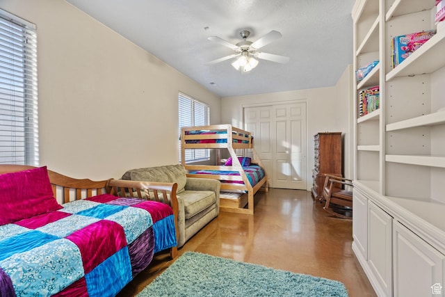 bedroom featuring a textured ceiling, ceiling fan, and a closet