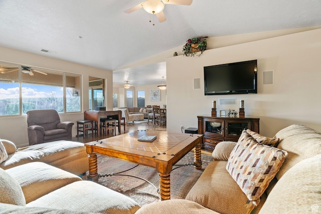 living room featuring wood-type flooring, vaulted ceiling, and ceiling fan