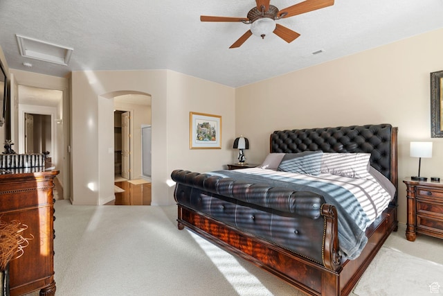bedroom with light carpet and a textured ceiling