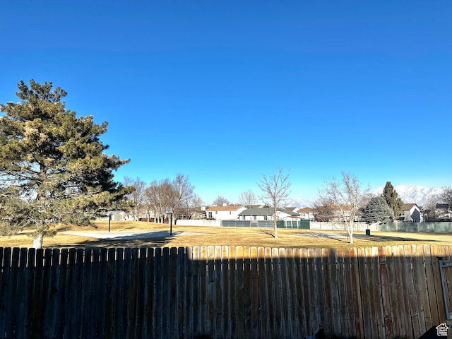 view of yard featuring a residential view and fence