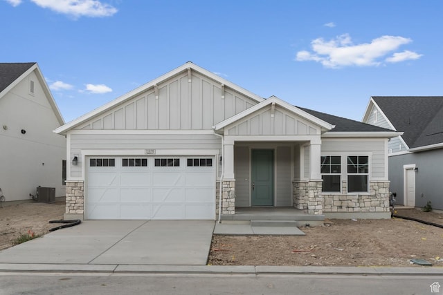 craftsman house featuring a garage and central AC unit