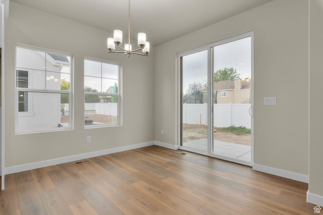 11878 S Golden Pine Ln, Riverton, UT 84065 - unfurnished dining area featuring an inviting chandelier and wood-type flooring