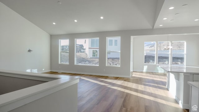 877 W Sika Cir S Unit 203, Saratoga Springs, UT 84045 - unfurnished living room featuring a chandelier, recessed lighting, light wood-style flooring, and baseboards