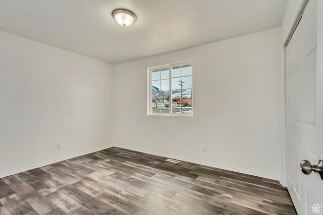 241 E Utah Ave, Tooele, UT 84074 - spare room with visible vents, baseboards, and dark wood-style flooring