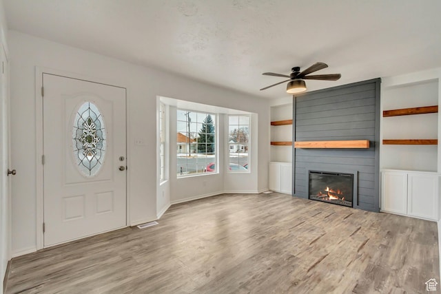 241 E Utah Ave, Tooele, UT 84074 - foyer entrance with ceiling fan, wood finished floors, and a fireplace
