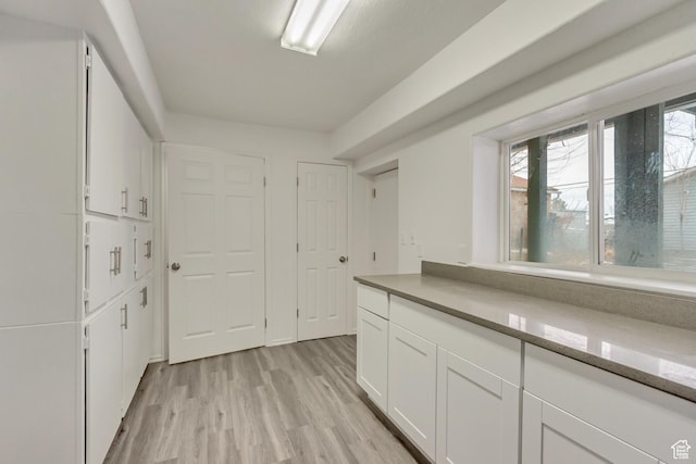 241 E Utah Ave, Tooele, UT 84074 - kitchen with white cabinets and light wood-type flooring