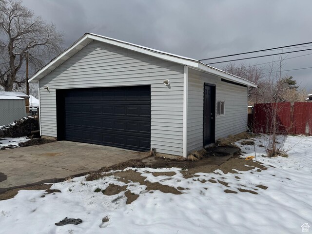 241 E Utah Ave, Tooele, UT 84074 - snow covered garage with a detached garage and fence