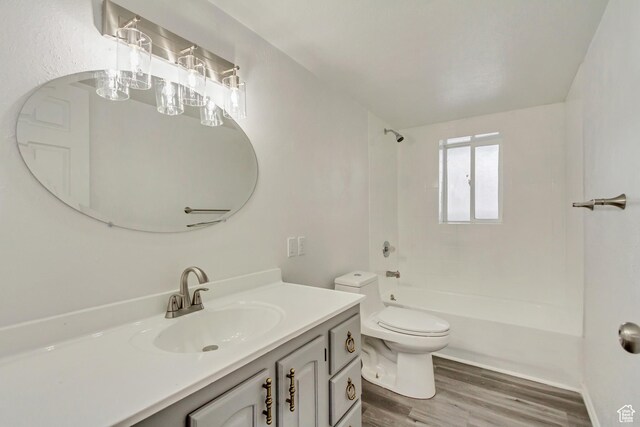 241 E Utah Ave, Tooele, UT 84074 - full bathroom featuring vanity, bathing tub / shower combination, toilet, and wood finished floors