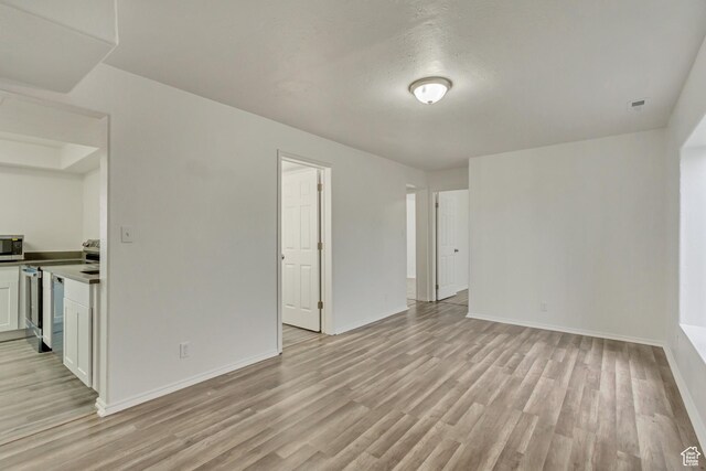 241 E Utah Ave, Tooele, UT 84074 - empty room featuring visible vents, light wood-style floors, and baseboards
