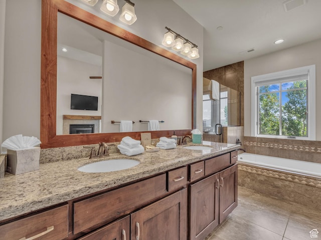 4163 Fairway Ln Unit B-4, Park City, UT 84098 - bathroom with double vanity, a stall shower, a garden tub, tile patterned floors, and a glass covered fireplace