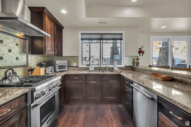 4163 Fairway Ln Unit B-4, Park City, UT 84098 - kitchen featuring wall chimney exhaust hood, sink, light stone counters, appliances with stainless steel finishes, and dark hardwood / wood-style flooring