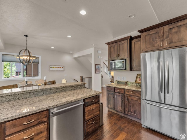 4163 Fairway Ln Unit B-4, Park City, UT 84098 - kitchen with appliances with stainless steel finishes, dark wood-style flooring, light stone countertops, a chandelier, and recessed lighting