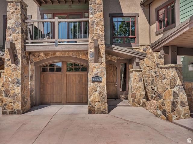 4163 Fairway Ln Unit B-4, Park City, UT 84098 - property entrance with stone siding, driveway, a garage, a balcony, and stucco siding