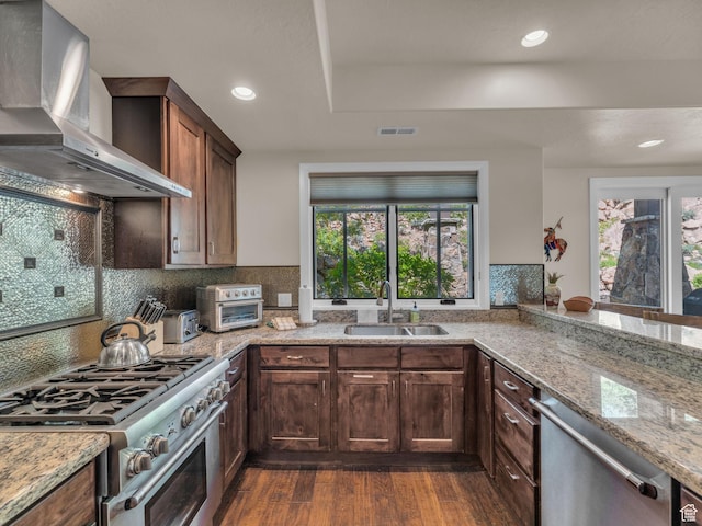 4163 Fairway Ln Unit B-4, Park City, UT 84098 - kitchen with wall chimney range hood, a sink, stainless steel appliances, dark wood-style flooring, and light stone counters