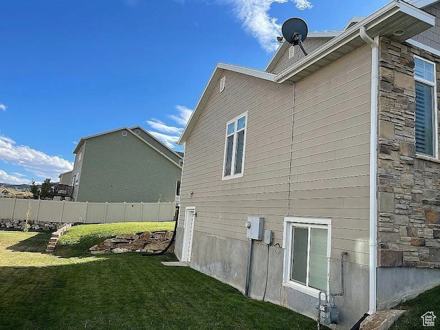 view of side of property with a yard