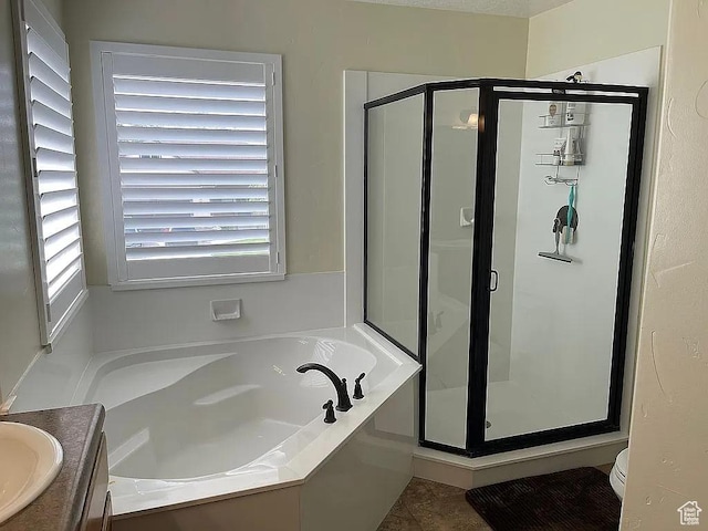 full bathroom with vanity, tile patterned floors, shower with separate bathtub, and toilet