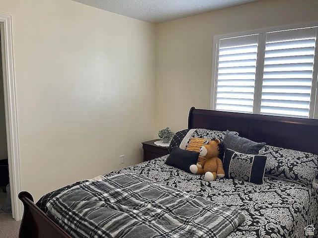 bedroom with carpet flooring and a textured ceiling