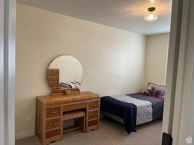 carpeted bedroom featuring a textured ceiling
