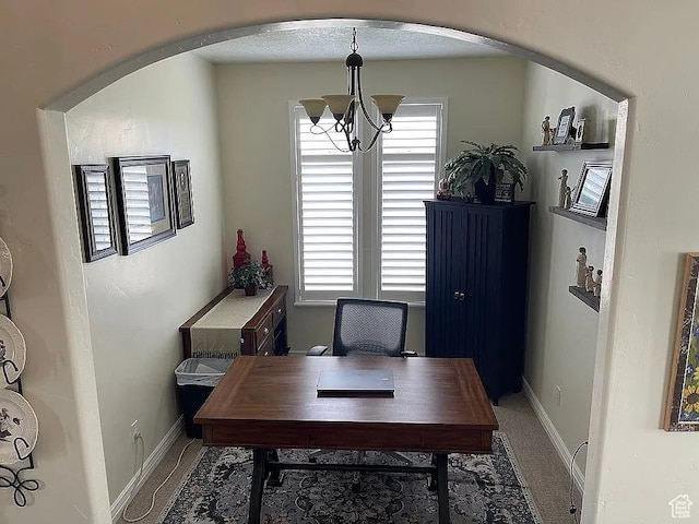 dining area featuring an inviting chandelier, carpet, and a wealth of natural light