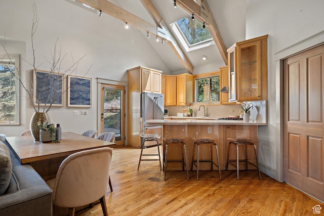 1204 E Gilmer Dr, Salt Lake City, UT 84105 - kitchen featuring a skylight, freestanding refrigerator, light wood-type flooring, and a wealth of natural light