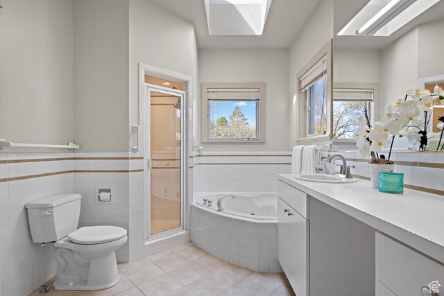 1204 E Gilmer Dr, Salt Lake City, UT 84105 - full bathroom with a shower stall, vanity, a tub with jets, toilet, and tile patterned floors