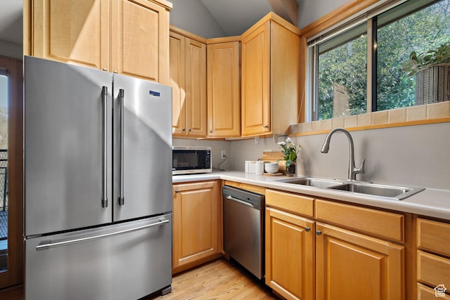 1204 E Gilmer Dr, Salt Lake City, UT 84105 - kitchen featuring vaulted ceiling, light countertops, a sink, stainless steel appliances, and light wood finished floors