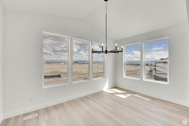 6184 W Teton Ranch Dr S Unit 304, Herriman, UT 84096 - unfurnished dining area with a chandelier, vaulted ceiling, wood finished floors, and baseboards