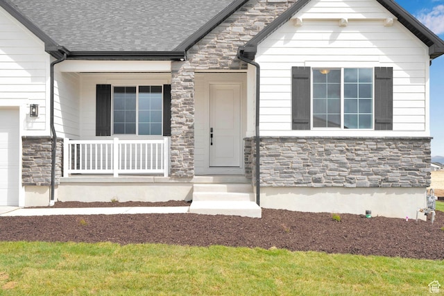 6184 W Teton Ranch Dr S Unit 304, Herriman, UT 84096 - view of front of property featuring stone siding, a shingled roof, and a porch