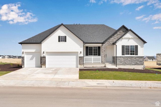 6184 W Teton Ranch Dr S Unit 304, Herriman, UT 84096 - view of front facade featuring stone siding, concrete driveway, a front lawn, and roof with shingles