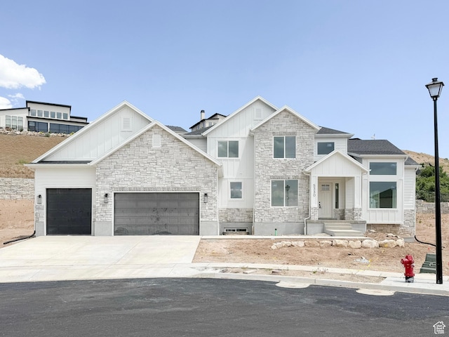 5330 N Springview Ct Unit 105, Lehi, UT 84043 - view of front of house featuring stone siding, an attached garage, board and batten siding, and concrete driveway