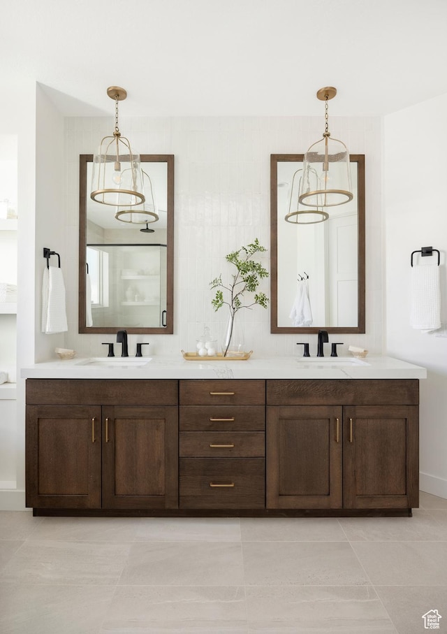 full bathroom featuring tile patterned floors, a sink, and double vanity