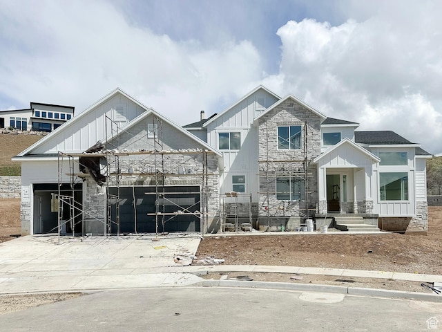 view of front of home with board and batten siding and stone siding