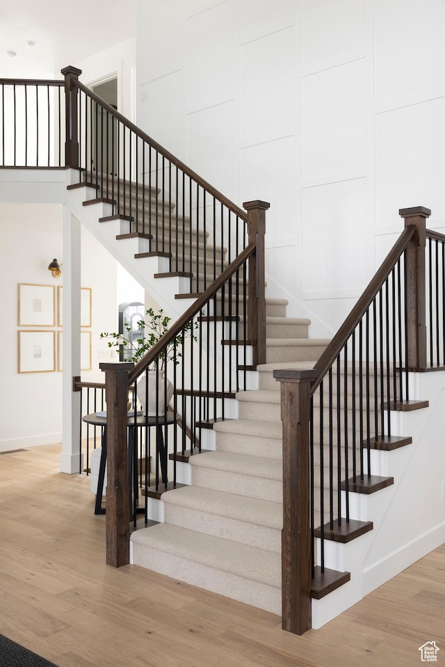 stairs featuring baseboards and wood finished floors