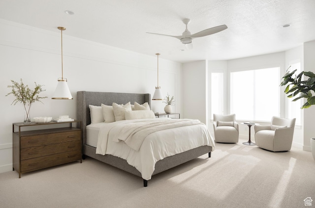 bedroom featuring light carpet and a ceiling fan