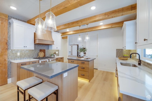 1292 S 1220 E, Salem, UT 84653 - kitchen featuring a sink, a center island, light wood-style flooring, tasteful backsplash, and white refrigerator with ice dispenser