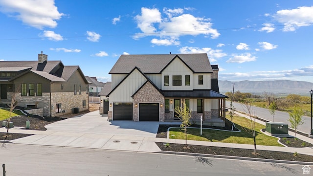 1292 S 1220 E, Salem, UT 84653 - view of front of home with concrete driveway, board and batten siding, an attached garage, a porch, and a standing seam roof