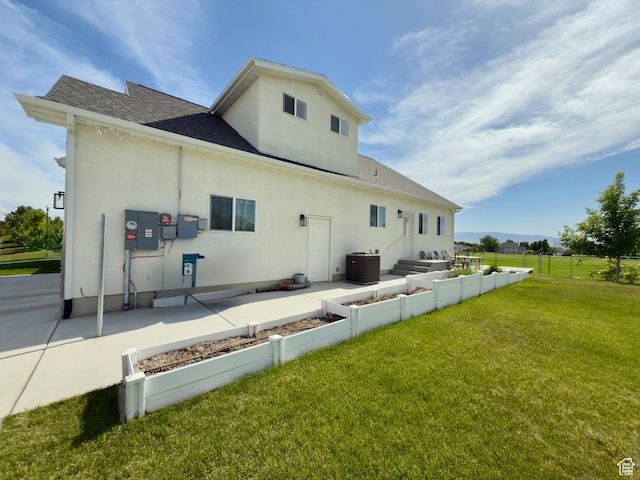 1855 N 860 W, Orem, UT 84057 - rear view of house featuring roof with shingles, stucco siding, central air condition unit, outdoor lounge area, and a patio