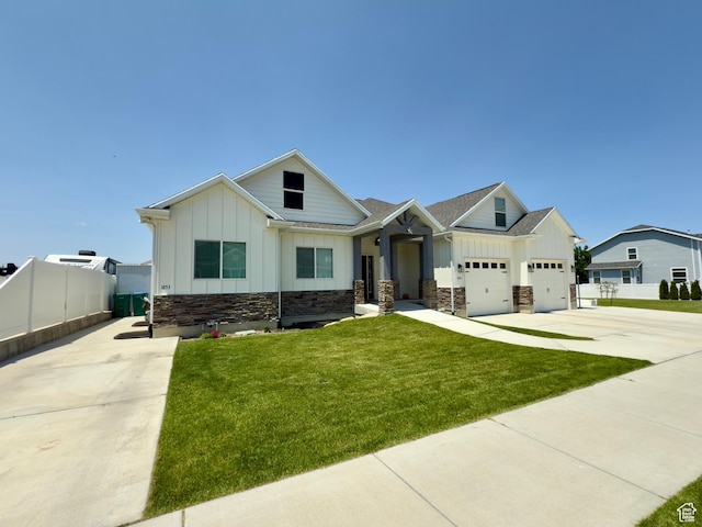 1855 N 860 W, Orem, UT 84057 - view of front facade featuring board and batten siding, concrete driveway, stone siding, and a garage