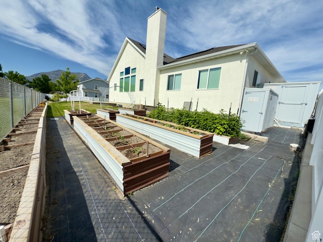 1855 N 860 W, Orem, UT 84057 - view of property's community with a vegetable garden, a mountain view, and a gate