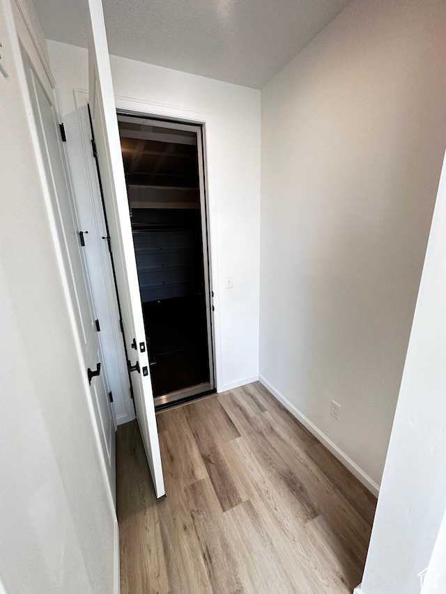 entryway with wood finished floors and baseboards