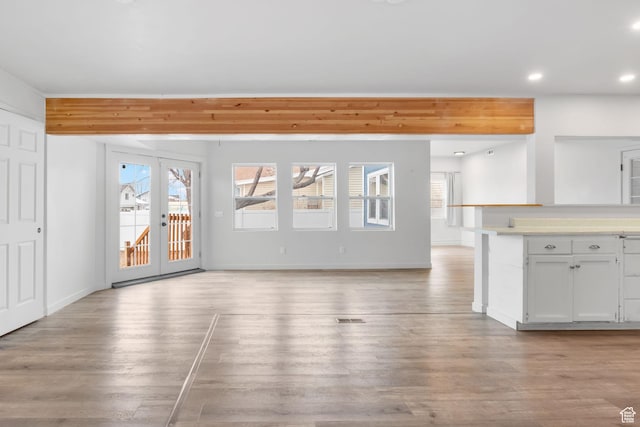 506 S 330 E, American Fork, UT 84003 - unfurnished living room with french doors, light wood-type flooring, and a healthy amount of sunlight