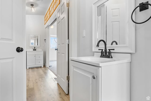 506 S 330 E, American Fork, UT 84003 - bathroom with two vanities, visible vents, a sink, and wood finished floors