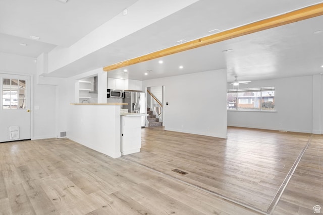 506 S 330 E, American Fork, UT 84003 - unfurnished living room with visible vents, ceiling fan, light wood-style floors, recessed lighting, and stairs