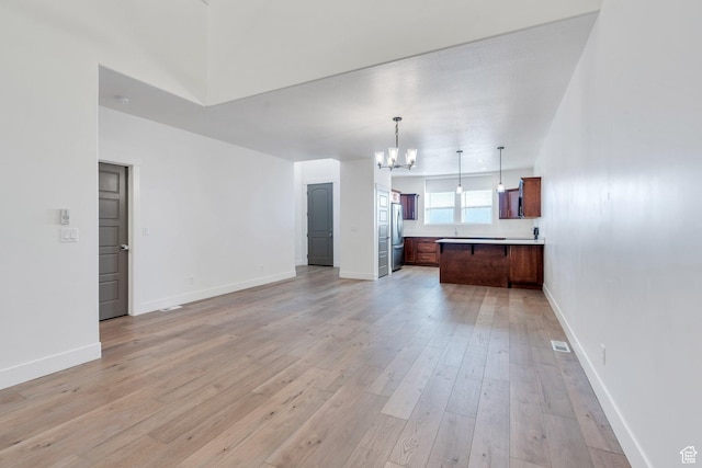 1455 N 3600 W, Lehi, UT 84043 - unfurnished living room featuring a chandelier and light wood-type flooring