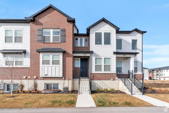view of property with a front yard and central air condition unit