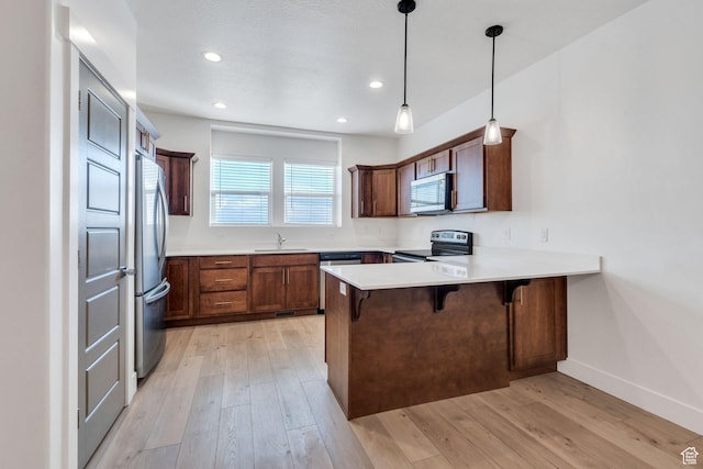 1455 N 3600 W, Lehi, UT 84043 - kitchen with a kitchen bar, sink, appliances with stainless steel finishes, kitchen peninsula, and pendant lighting